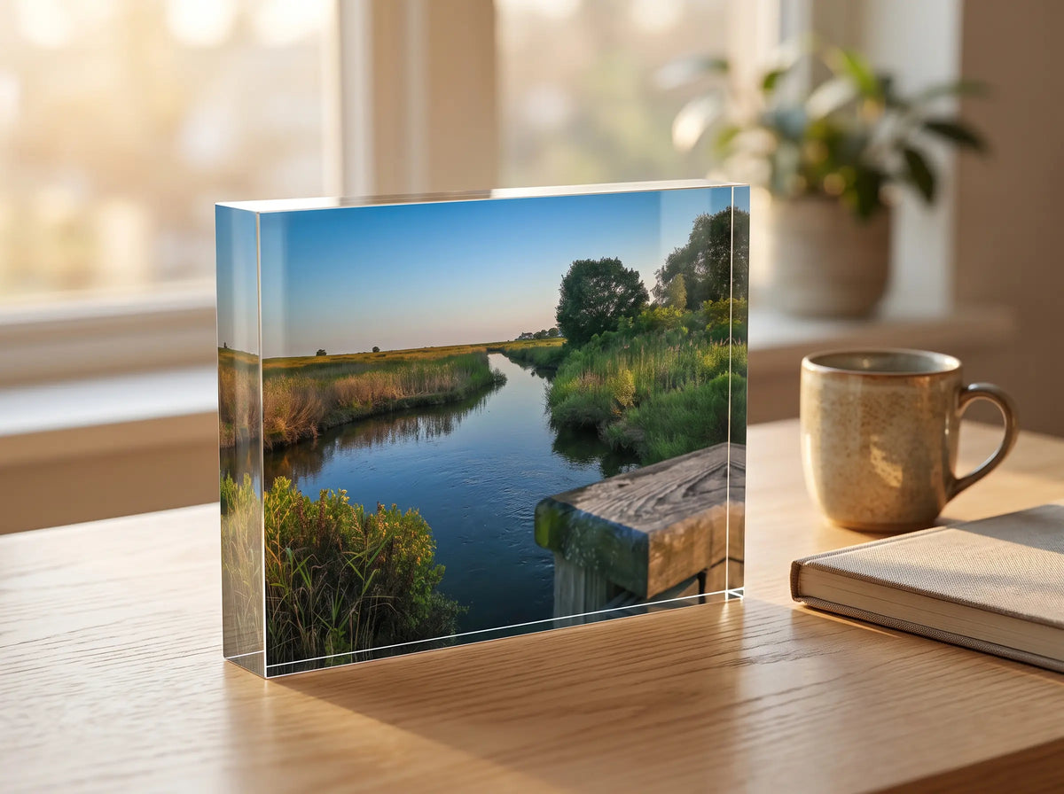 Acrylic block print of a marsh river on a desk