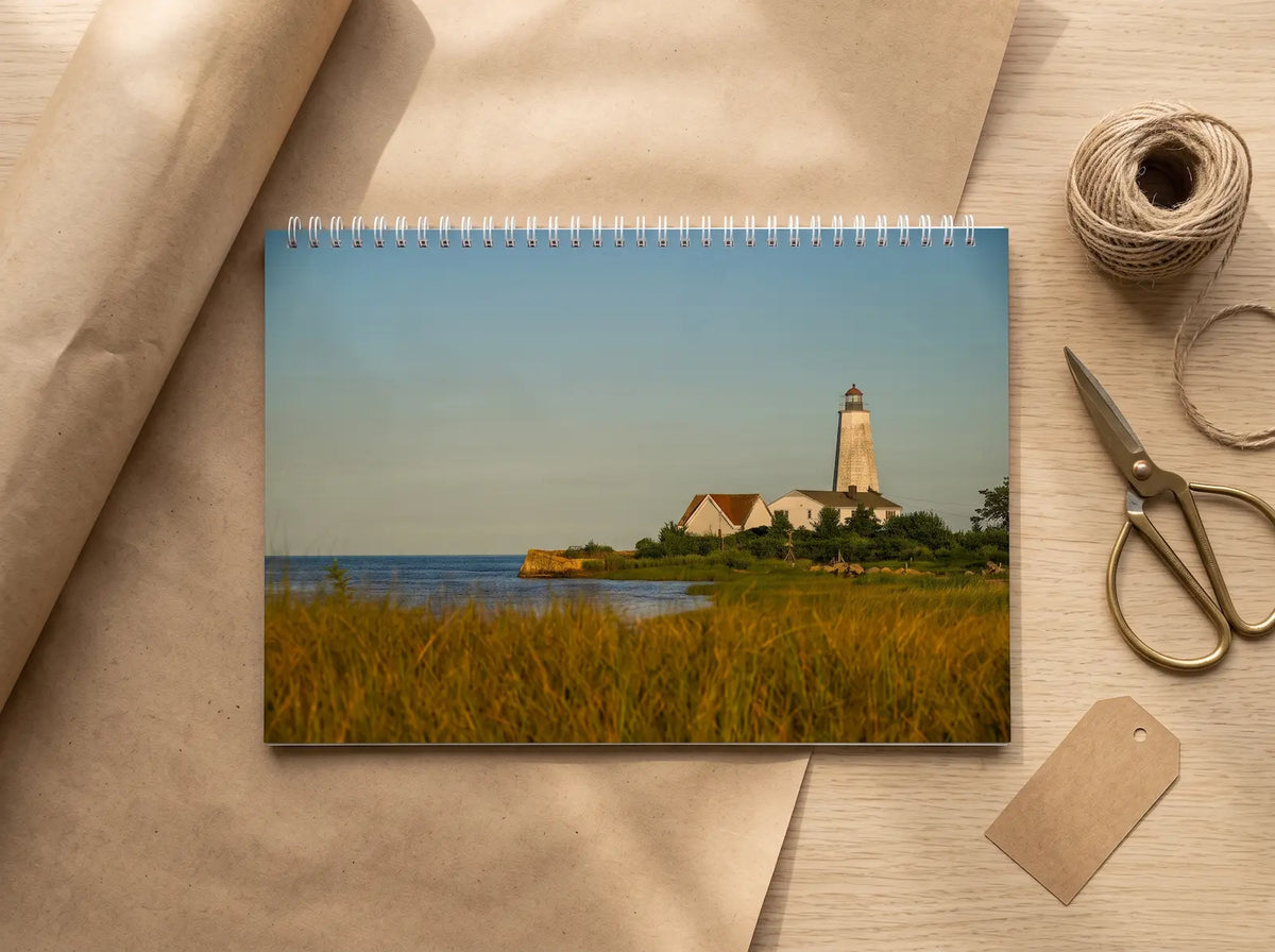 New England Lighthouses 2027 wall calendar on kraft paper beside twine and scissors